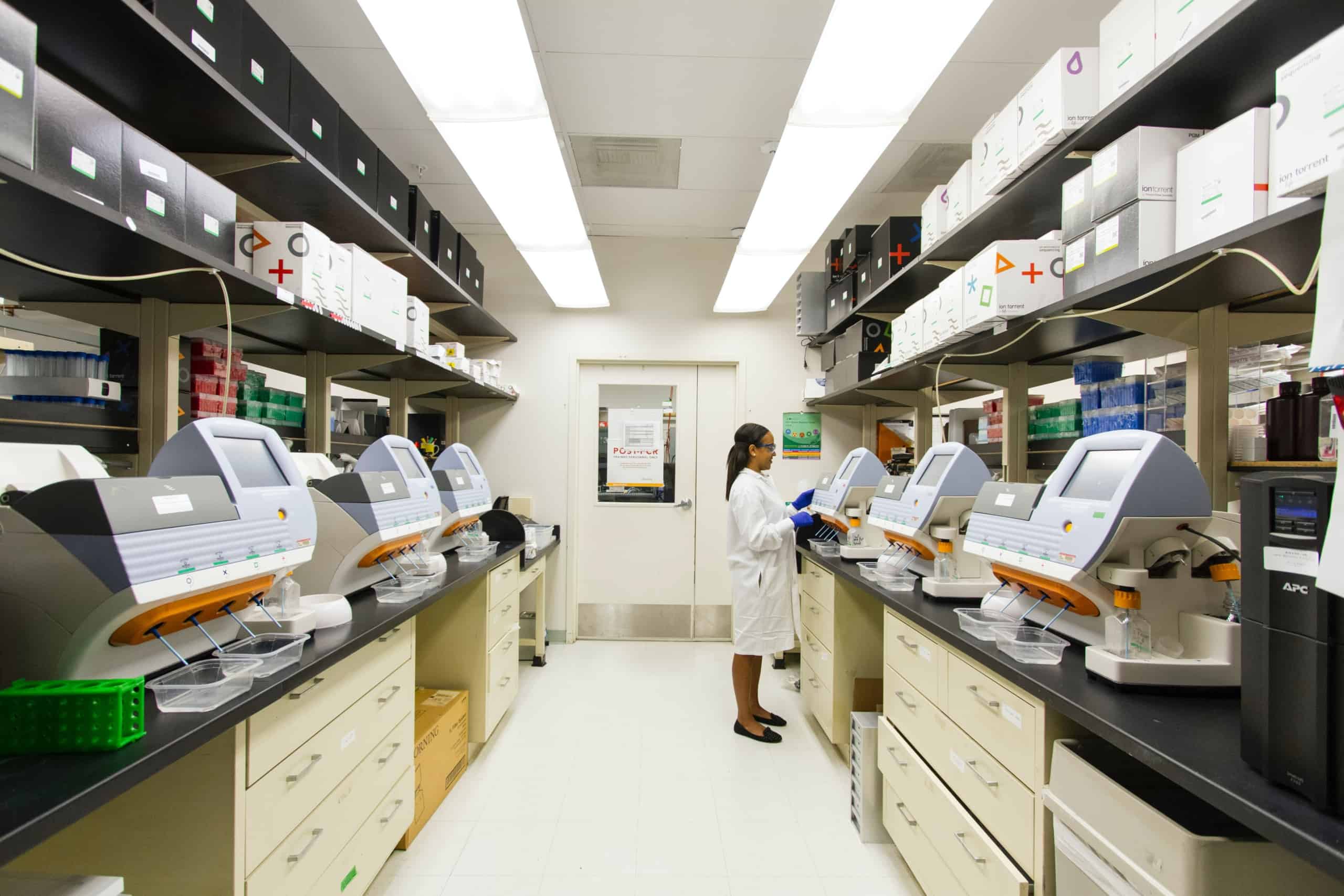 DNA Genotyping and Sequencing.A technician works among a fleet of desktop genomic sequencing machines at the Cancer Genomics Research Laboratory, part of the National Cancer Institute's Division of Cancer Epidemiology and Genetics (DCEG). Creator: Daniel Sone