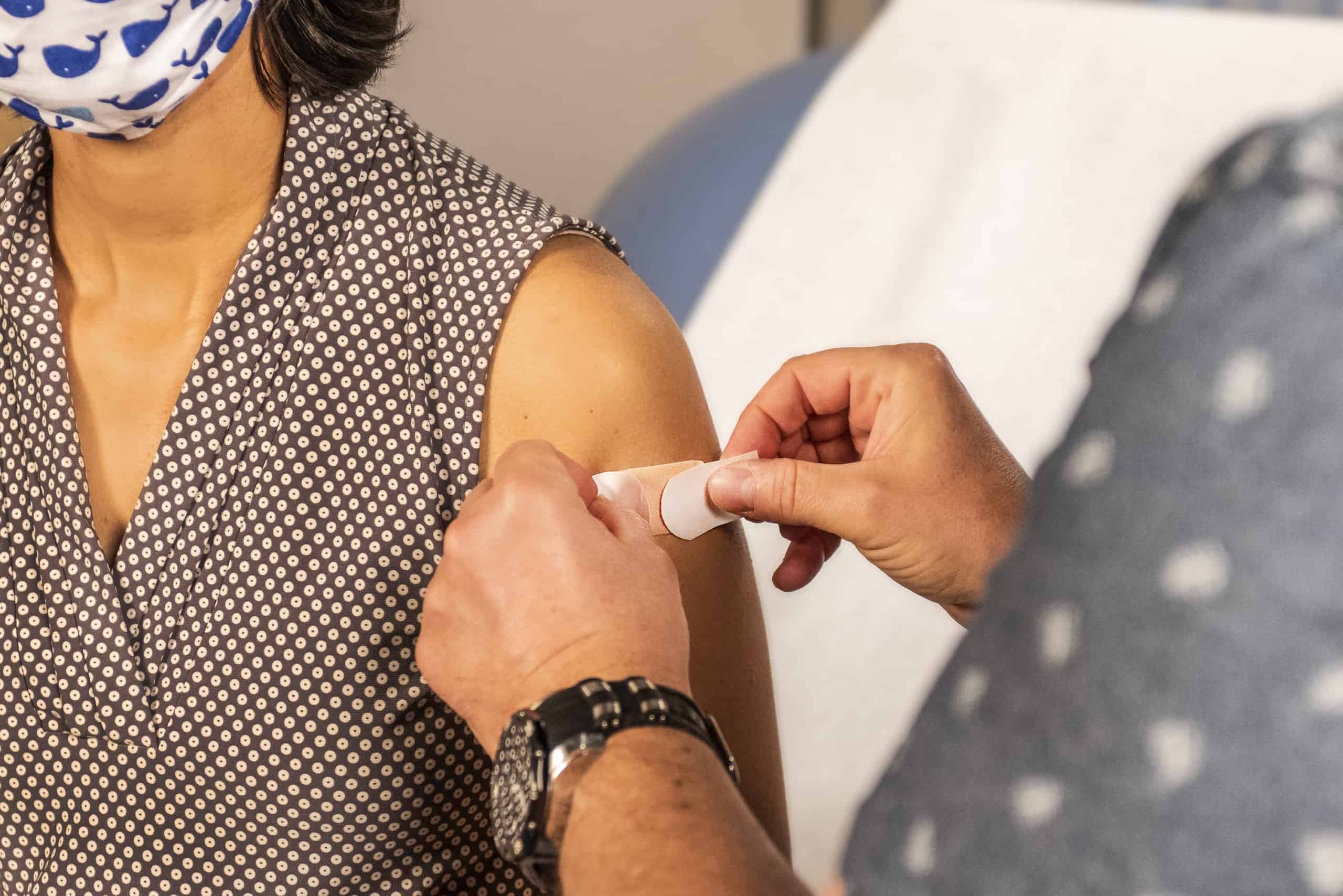 In this 2020 photograph, captured inside a clinical setting, a bandage has been placed on the injection site of a patient, who just received an influenza vaccine. The best way to prevent seasonal flu, is to get vaccinated every year. Centers for Disease Control and Prevention (CDC) recommends everyone 6-months of age and older get a flu vaccine every season.